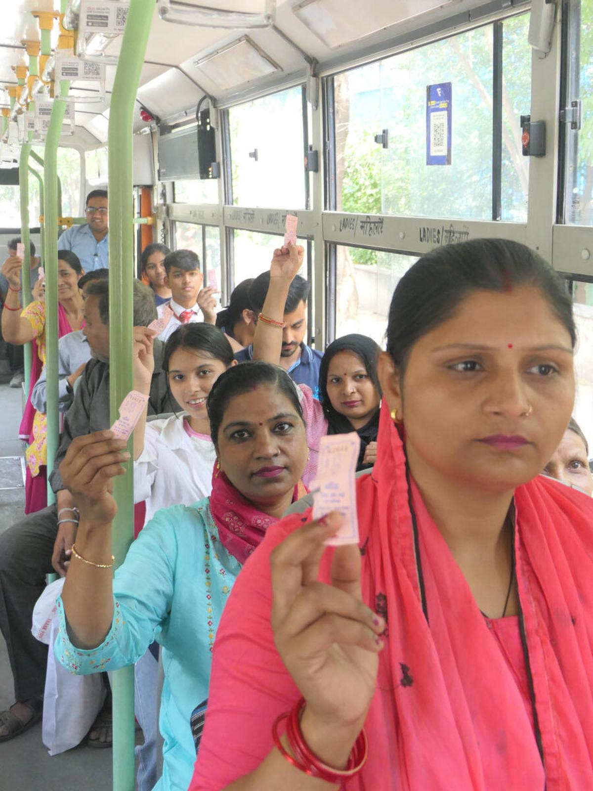 Women showing ‘pink tickets’ of Delhi Transport Corporation in April 2024